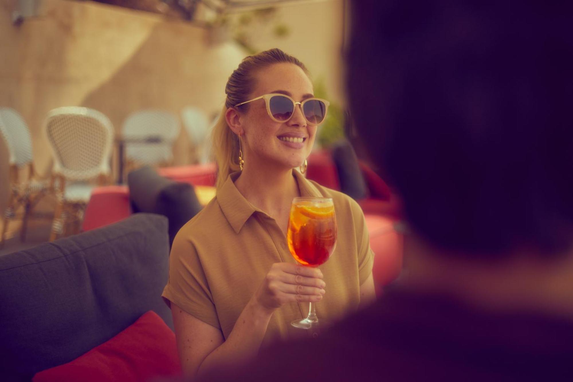 Secrets Mallorca Villamil Resort & Spa - Adults Only Peguera Ngoại thất bức ảnh A woman drinking an Aperol Spritz